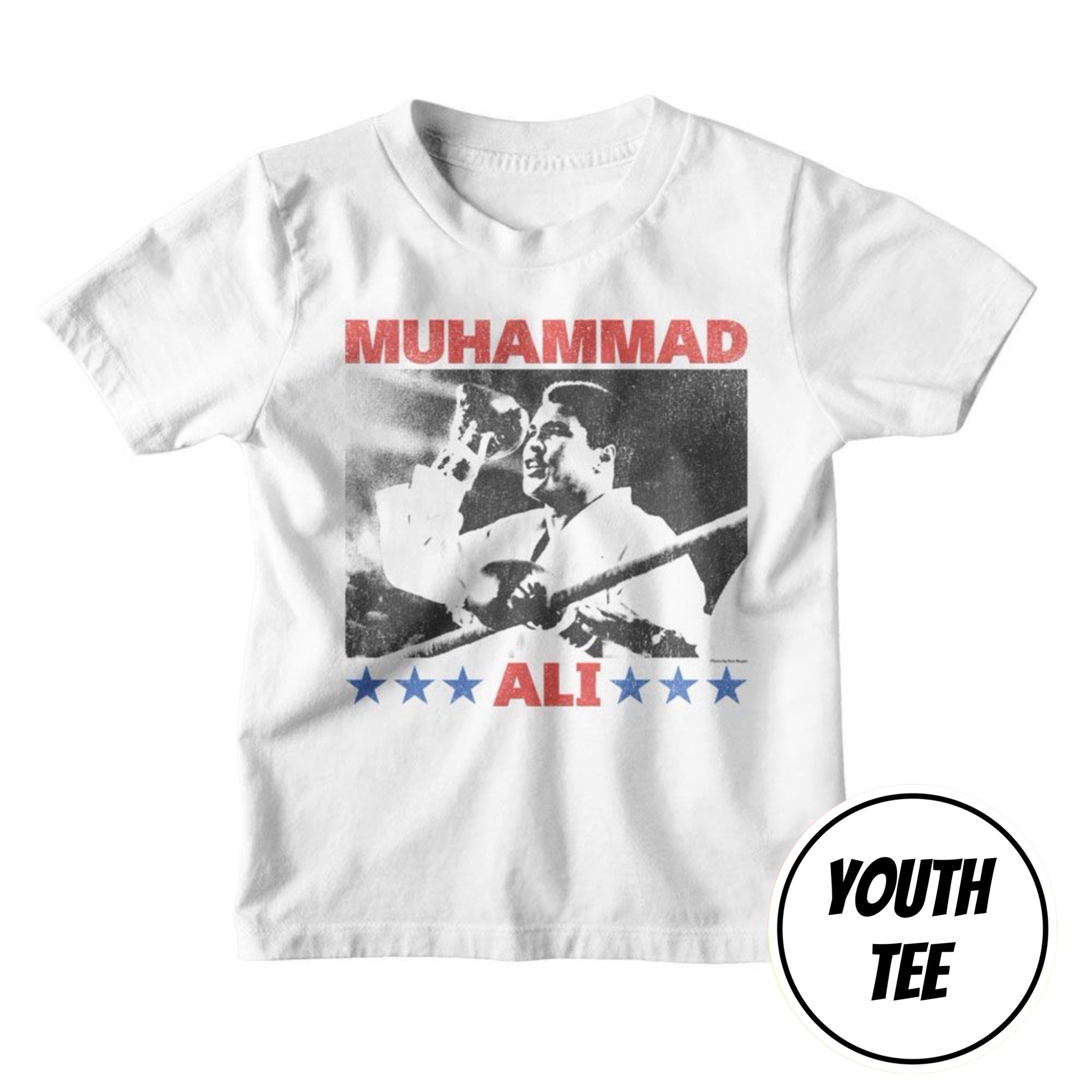 A white youth t-shirt featuring a graphic print of Muhammad Ali with red text reading 'MUHAMMAD' and 'ALI', blue stars, and a black-and-white photo. A circular badge in the bottom right corner reads 'YOUTH TEE'.