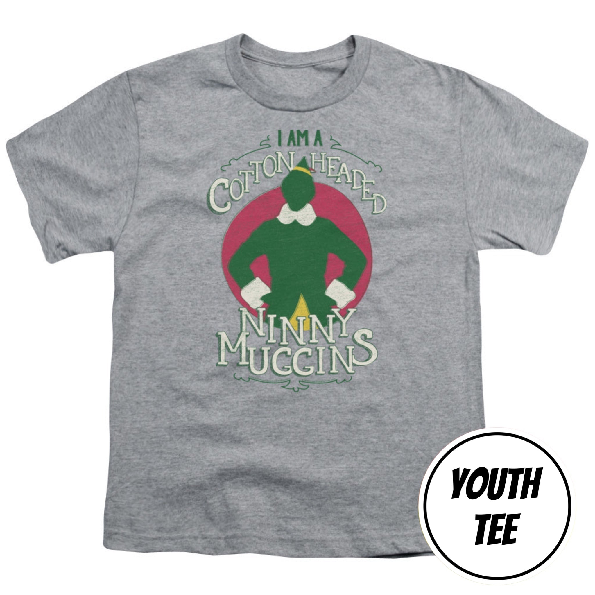 A youth heather gray t-shirt featuring a graphic of Buddy the Elf with the text 'I AM A COTTON-HEADED NNYY MUCCINS'. A white circular badge in the bottom right corner reads 'YOUTH TEE'.