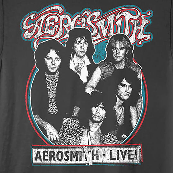 A black short-sleeve crewneck t-shirt featuring a vintage-style graphic print of the band Aerosmith. The graphic includes the band's name in stylized red and white lettering at the top, a circular black-and-white photo of the five band members in the center, and a white banner at the bottom reading 'AEROSMITH LIVE'.