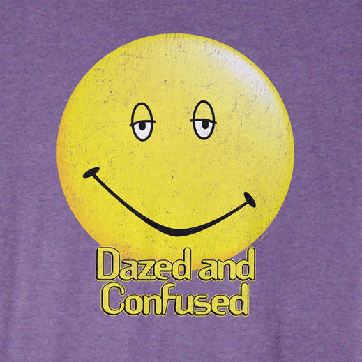 Purple t-shirt with a yellow smiley face and 'Dazed and Confused' text on a white background