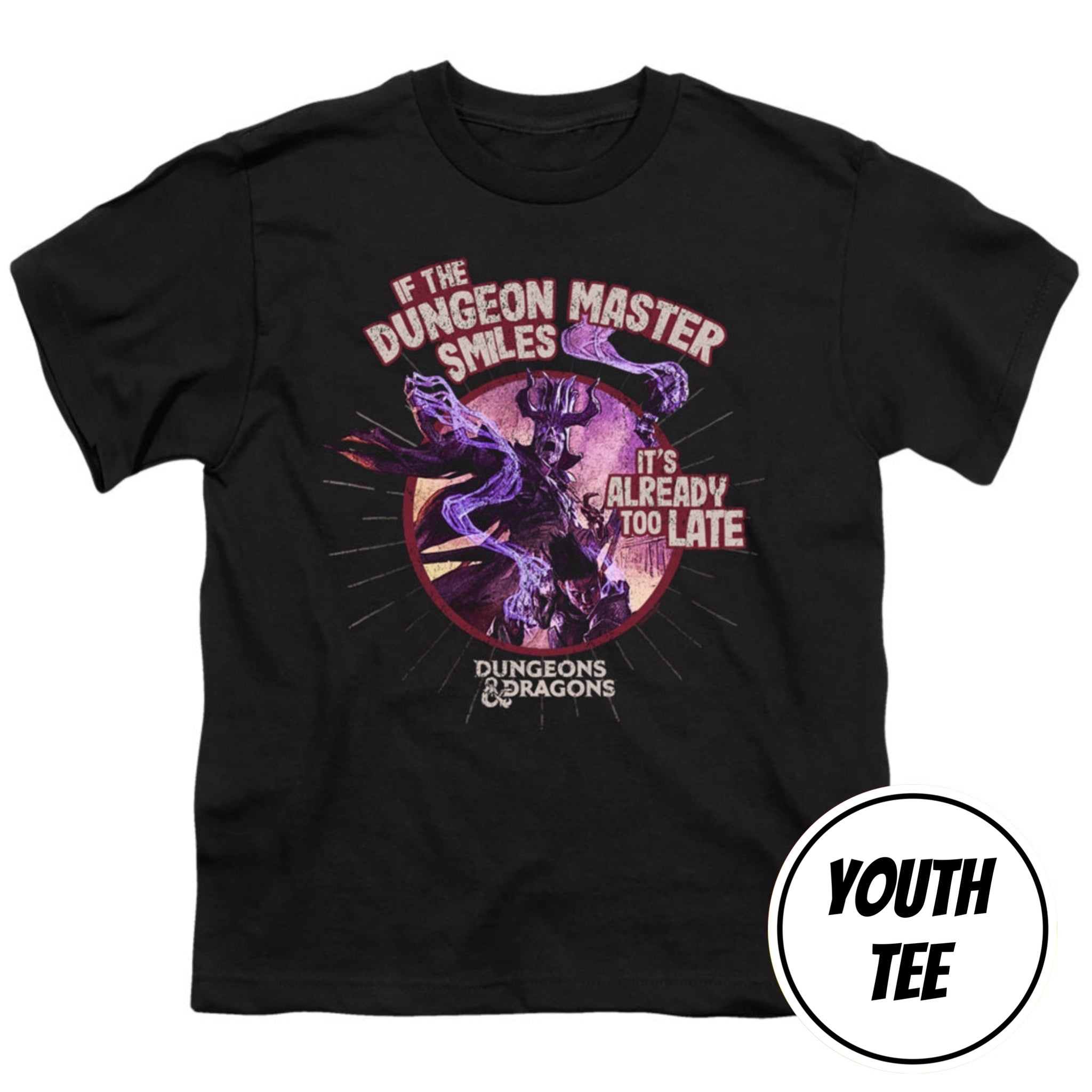 A youth black t-shirt featuring a Dungeons & Dragons graphic with a purple dragon and the text 'IF THE DUNGEON MASTER SMILES IT'S ALREADY TOO LATE'. A white circular badge in the bottom right corner reads 'YOUTH TEE'.