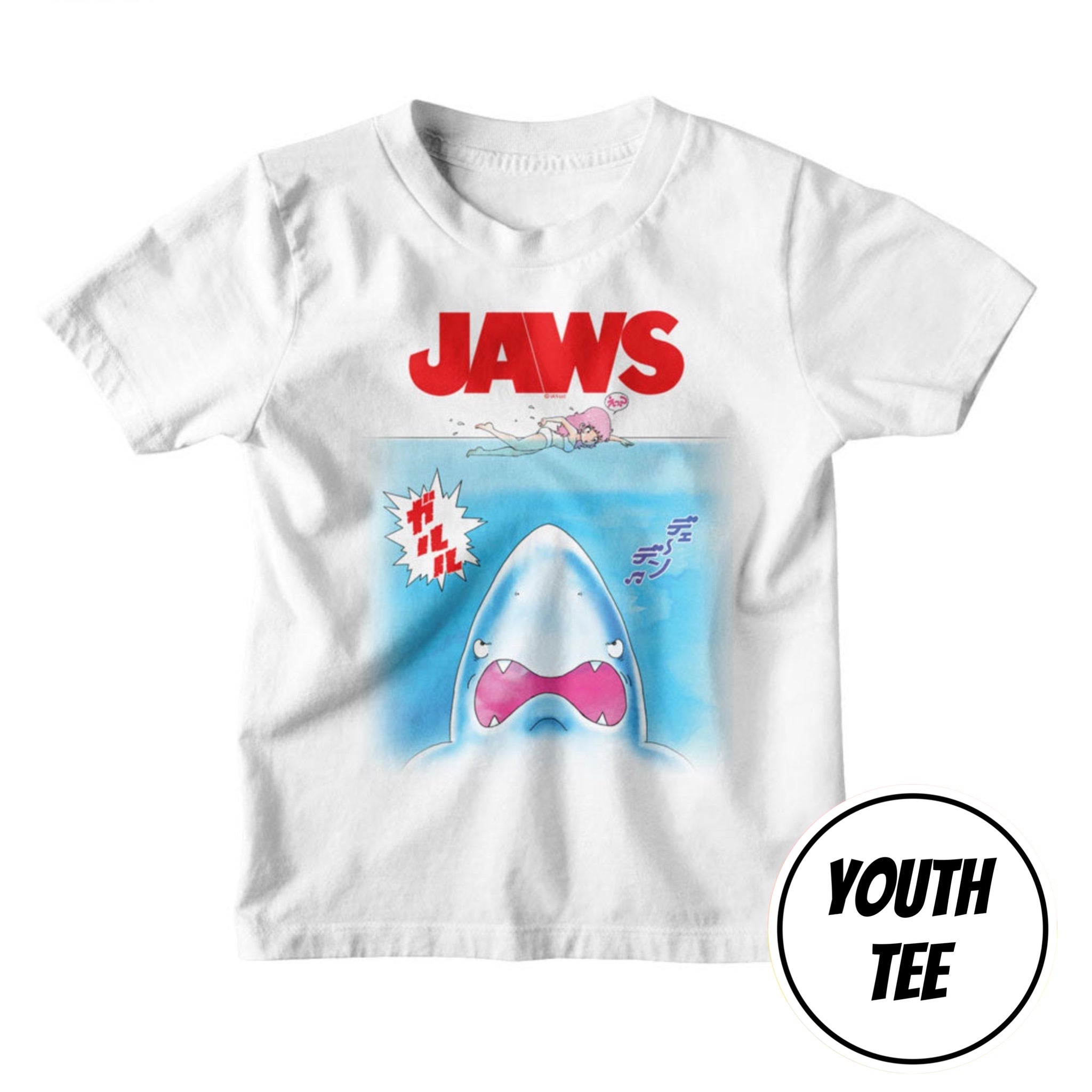 A white youth t-shirt featuring a 'Jaws' movie graphic print with a cartoon shark and red 'JAWS' text, shown on a plain white background with a 'YOUTH TEE' badge overlay.