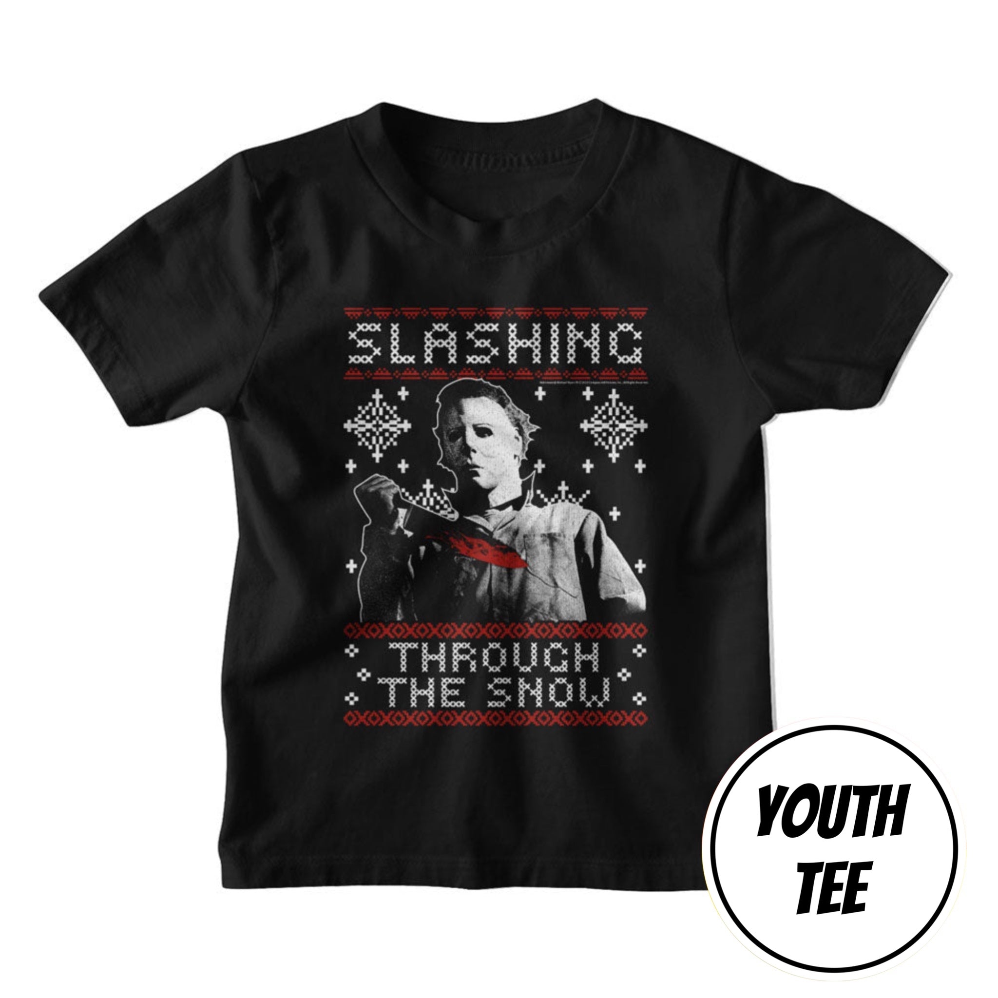 A youth black short-sleeve t-shirt featuring a Christmas sweater-style graphic of Michael Myers from Slasher holding a bloody chainsaw, with the text 'SLASHING THROUGH THE SNOW' in white and red. A circular badge in the bottom right corner reads 'YOUTH TEE'.