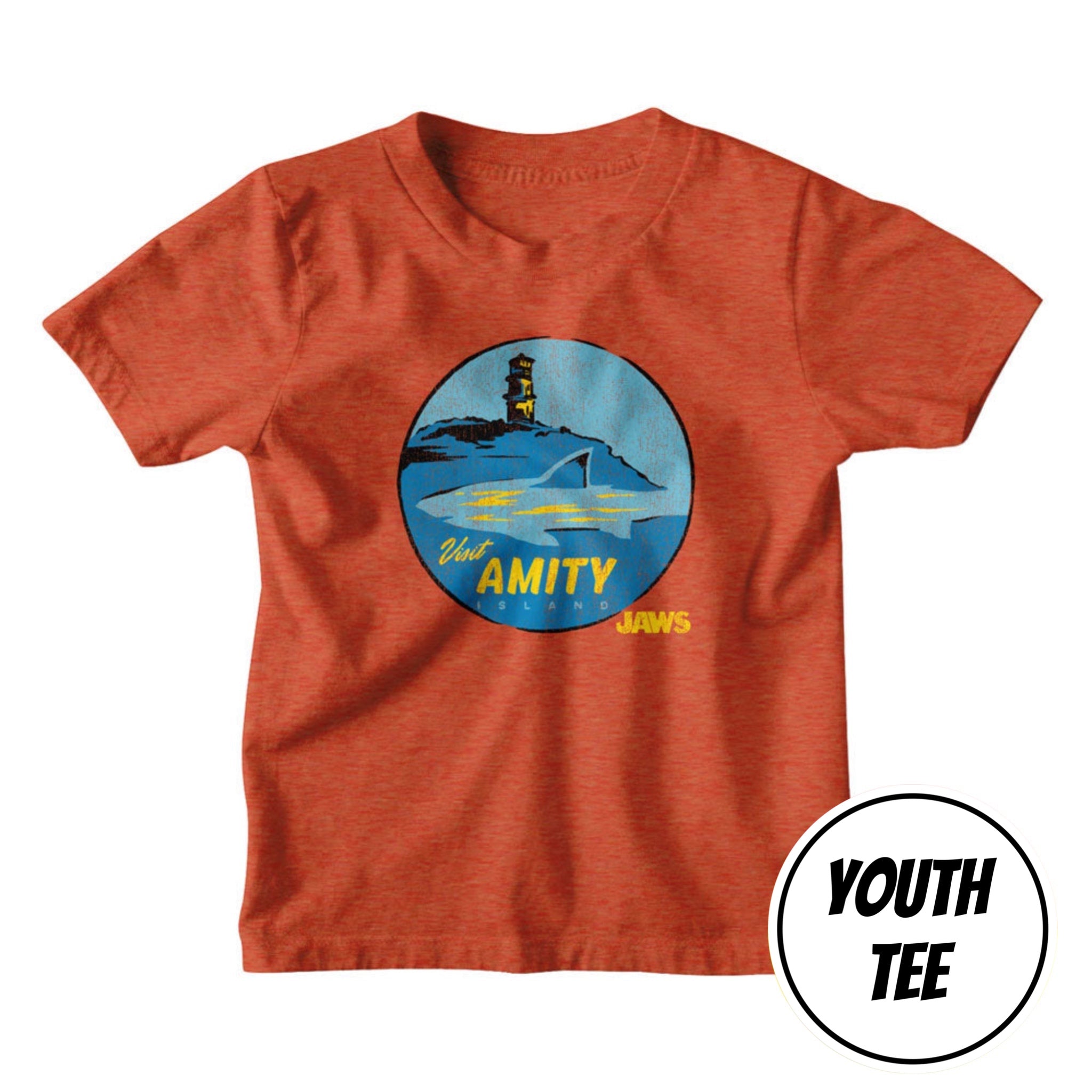A youth heather orange t-shirt featuring a circular 'Jaws' movie graphic on the chest with a shark, lighthouse, and the words 'Old AMITY MEANS JAWS'. A white circular badge in the bottom right corner reads 'YOUTH TEE'.