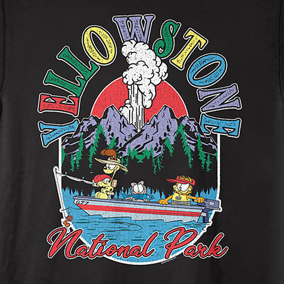A black short-sleeve graphic t-shirt featuring a colorful cartoon print of characters in a boat on Yellowstone National Park water, with 'Yellowstone National Park' text and mountains in the background.