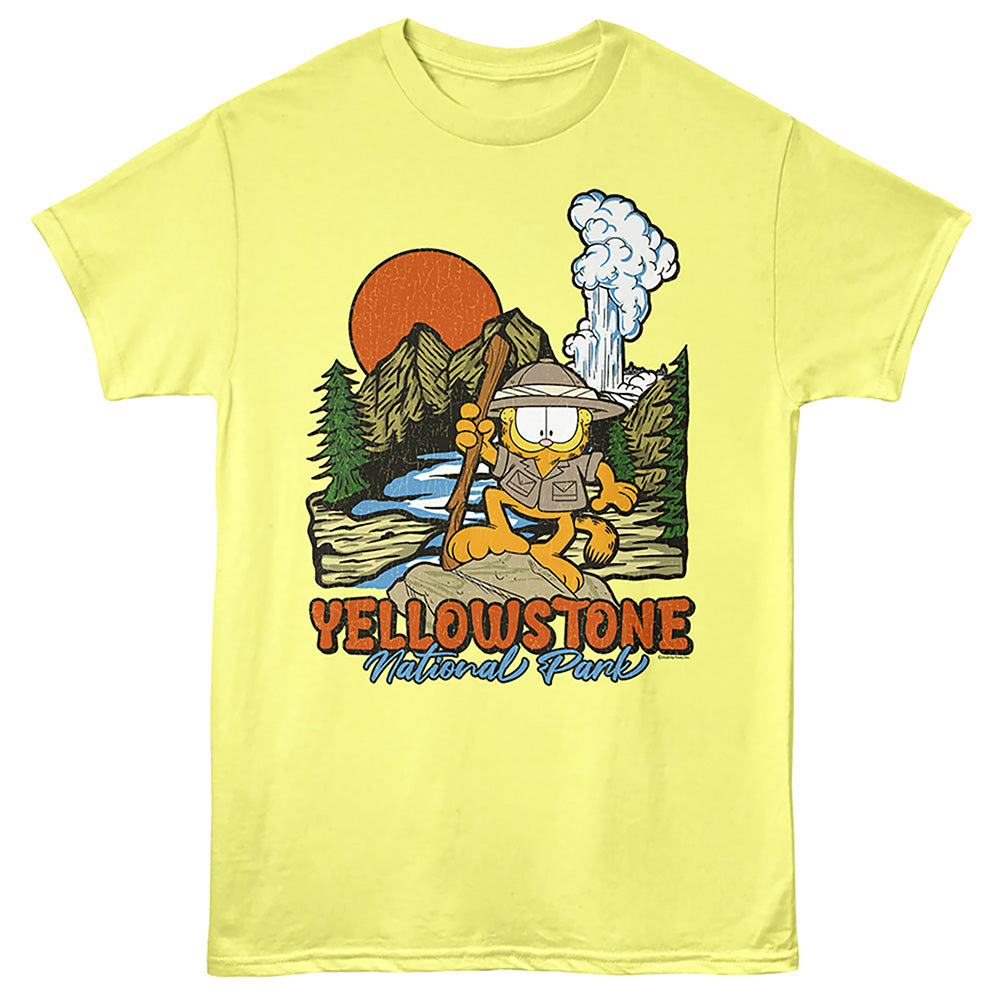 A pale yellow short-sleeve t-shirt featuring a colorful graphic of Garfield as a hiker in Yellowstone National Park, with an orange sun, mountains, and the text 'YELLOWSTONE National Park' printed below.