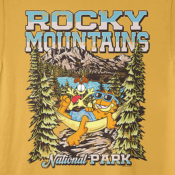 A yellow short-sleeve crewneck t-shirt featuring a colorful graphic print of Garfield and Tommy the Beaver relaxing in a canoe in front of a mountain landscape with pine trees, with 'ROCKY MOUNTAINS National Park' text.