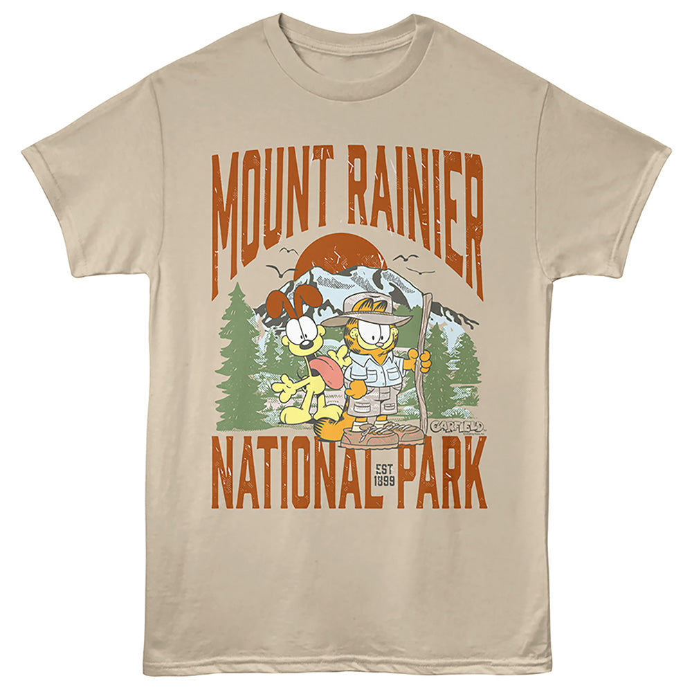 A beige crewneck t-shirt featuring a colorful graphic print of Garfield and Catbus Charlie in front of a mountain, with 'MOUNT RAINIER NATIONAL PARK' printed in distressed orange text.