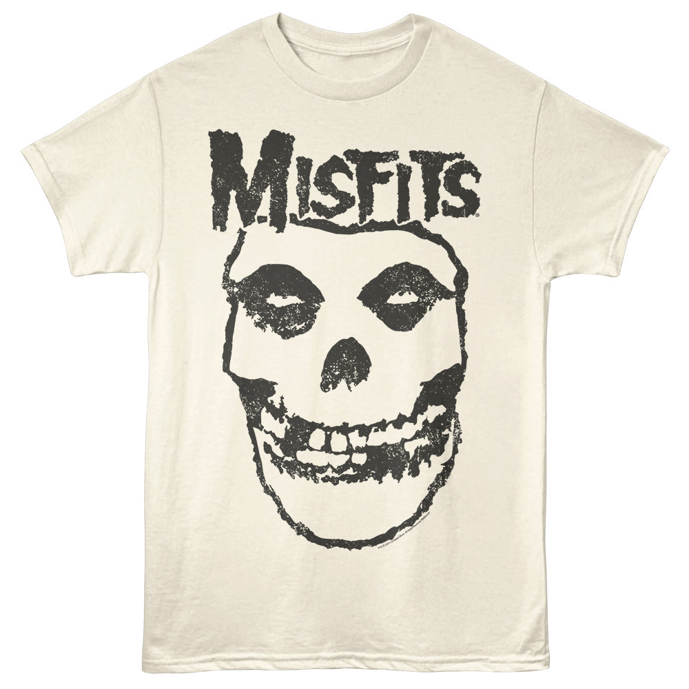 An off-white short-sleeve t-shirt featuring a distressed black graphic of a skull with the word 'Misfits' printed above it, shown against a plain natural background.