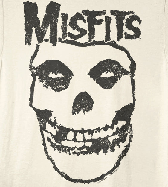 An off-white short-sleeve t-shirt featuring a distressed black graphic of a skull with the word 'Misfits' printed above it, shown against a plain natural background.