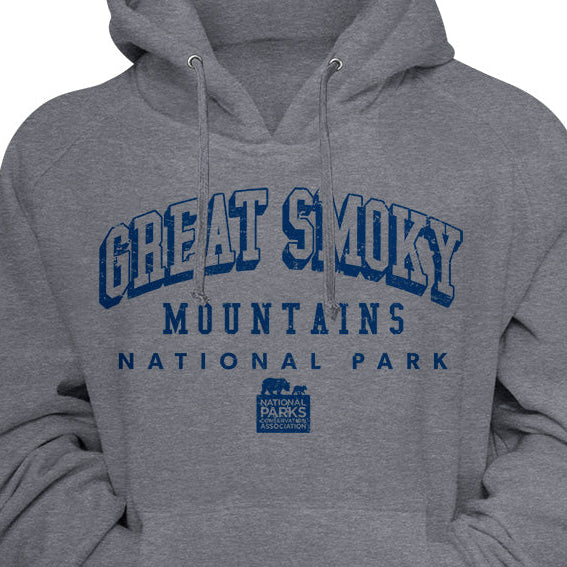 A heather gray pullover hoodie featuring 'GREAT SMOKY MOUNTAINS NATIONAL PARK' printed in blue across the chest, with a small park logo below the text.