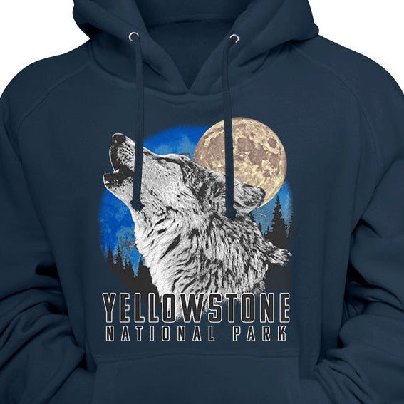 A navy blue pullover hoodie featuring a graphic print of a howling wolf in front of a full moon and blue sky, with the text 'YELLOWSTONE NATIONAL PARK' printed below.