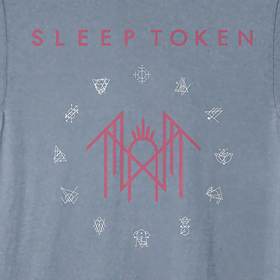 A heathered slate blue t-shirt featuring a pink graphic print on the front. The design displays the text 'SLEEP TOKEN' in pink at the top, a central pink stylized logo in the middle, and small white line-art symbols arranged in a circle around the center.