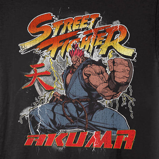 A black short-sleeve crewneck t-shirt featuring a colorful graphic print of Street Fighter's character Mikaru in a fighting pose, with 'Street Fighter' and 'Mikaru' text on a black background.